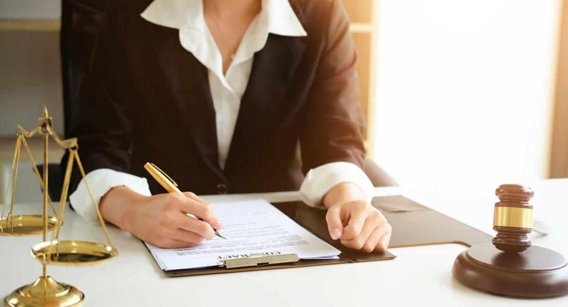 How Do I Find The Right Attorney For Me? - Professional Women Signing Document