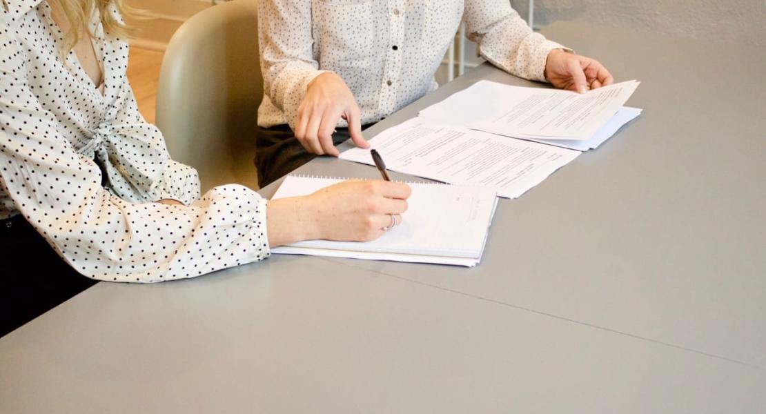 Person signing mediation papers Person signing mediation papers