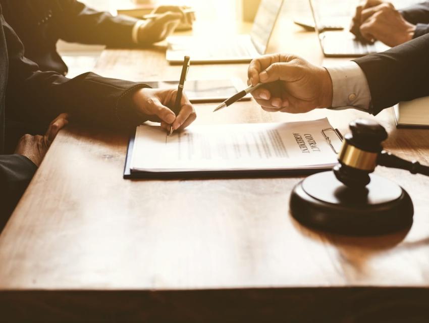 2 professionals at desk looking over documents